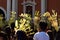 Catholics waving coconut palm leaves in celebrating Palm Sunday before Easter, Church tower background, The feast commemorates Jes