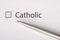 Catolic - checkbox with a tick on white paper with metal pen. Checklist concept