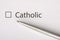 Catolic - checkbox with a tick on white paper with metal pen. Checklist concept