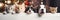 A cats and a dogs peeking out from behind a wooden board. Cute puppies and kittens with a defocused Christmas background