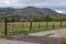 A cattle guard on farm driveway in the mountains