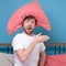 Cauacsian young man with pillow on head lying in bed and screaming being alone stressed because of quarantine