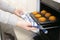 Caucasain woman holding tray with freshly made cupcakes or maffins at the kitchen