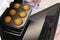 Caucasain woman holding tray with freshly made cupcakes or maffins at the kitchen