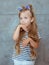 Caucasian adorable cute sweet little girl with long blonde hair in cat`s ears