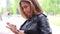 Caucasian adult woman female using iphone cellphone smartphone on street