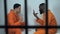 Caucasian and afro-american prisoners playing cards, illegal gambling in jail