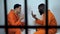 Caucasian and afro-american prisoners playing cards, illegal gambling in jail