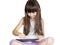 Caucasian angry child kid girl sister sitting on the bed with tablet pc isolated