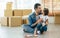 Caucasian beard handsome father and little adorable girl or daughter wearing casual jeans, sitting on floor, eating cookies