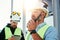 Caucasian bearded engineer with walkie-talkie control working process on construction site. Team of structural engineers working