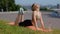 Caucasian beautiful female practicing yoga in nature using gym mat. Fit woman exercising. Positive young woman practices