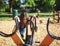 Caucasian beautiful girl climbs on a spinning swing in the park at the playground