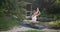 Caucasian beautiful sporty slim young woman doing yoga Physical training outdoors in the park