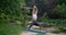 Caucasian beautiful sporty slim young woman doing yoga Physical training outdoors in the park