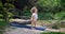 Caucasian beautiful sporty slim young woman doing yoga Physical training outdoors in the park