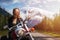 Caucasian Biker Woman on a Motorcycle on a scenic Road