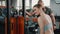 Caucasian blond athletic woman in her 20s with her hair tied up in a bun, focusing on doing an exercise for her triceps