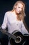 Caucasian Blond Female Posing with Guitar Against Black. Halogen and Flash Light Used