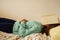 Caucasian blond teenage girl is lying on the bed and reading book