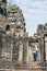 Caucasian blonde woman discovering the ruins of Angkor Wat temple complex in Siem Reap, Cambodia