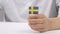 Caucasian boy of 9 years is keeping small flag of Sweden