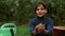 Caucasian boy on a bed in the garden.The child is engaged in spring planting.