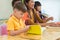 Caucasian boy ethnicity kid reading book white learning in classroom with friends and teacher in kindergarten school, education