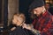 Caucasian boy getting haircut in barbershop indoor