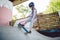 Caucasian boy in a helmet does tricks on a skateboard on a playground for skateboarding outside. A child skateboarder rides a