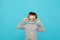 Caucasian boy holding round black and white lollipops, candies near the eyes. Celebration, fun, sweets for children. Copy space