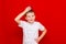 Caucasian boy kid child schoolboy holds a red Apple in his hands. Vitamins and fruits, healthy food. bright red wall