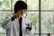 Caucasian boy in Lab coat playing with test tube and beaker in chemical classroom