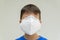 Caucasian boy with surgical mask covering his face