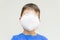 Caucasian boy with surgical mask covering his face