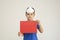 Caucasian boy with surgical mask on his head holding blank sheet