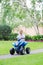 Caucasian boy toddler driving blue electric car on the road