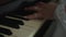 Caucasian bride plays beautifully with thin fingers on keys of old black