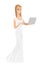 Caucasian bride in a white dress using laptop.
