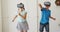 Caucasian brother and sister gesturing while wearing vr headset at home