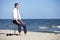 Caucasian business man resting, sitting on pneumatic stool on the beach