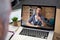 Caucasian businessman having coffee displayed on laptop screen during office video call