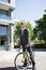 Caucasian businessman riding a bike