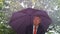 Caucasian businessman sheltering underneath an umbrella in the rain