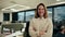 Caucasian businesswoman beautifully smiling standing with cross arms in office