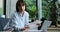 Caucasian Businesswoman Working from Home on Living Room Couch