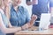 Caucasian businesswomen looking at laptop