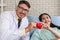 Caucasian cardiology doctor and asian patient holding heart shape ball together in concept of heart attack prevention campaign