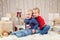 Caucasian children brother and sister in sweaters sitting together hugging celebrating Christmas or New Year