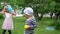 Caucasian children with mother throwing balls into camera. Gimbal movement